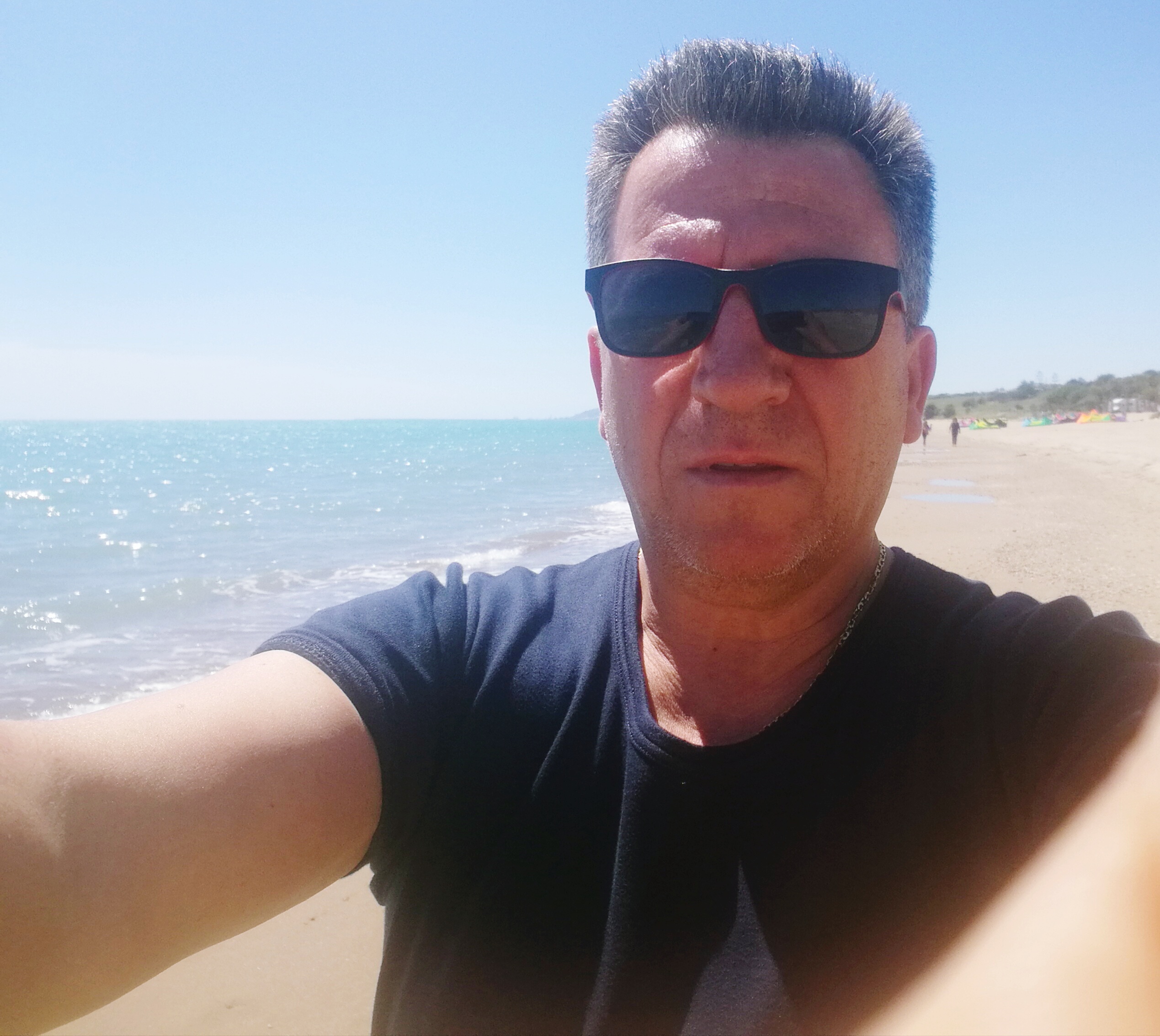 portrait-man-standing-shore-beach